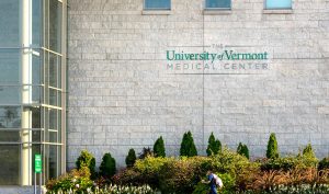 University of Vermont health network building A man walks past the University of Vermont health network building
